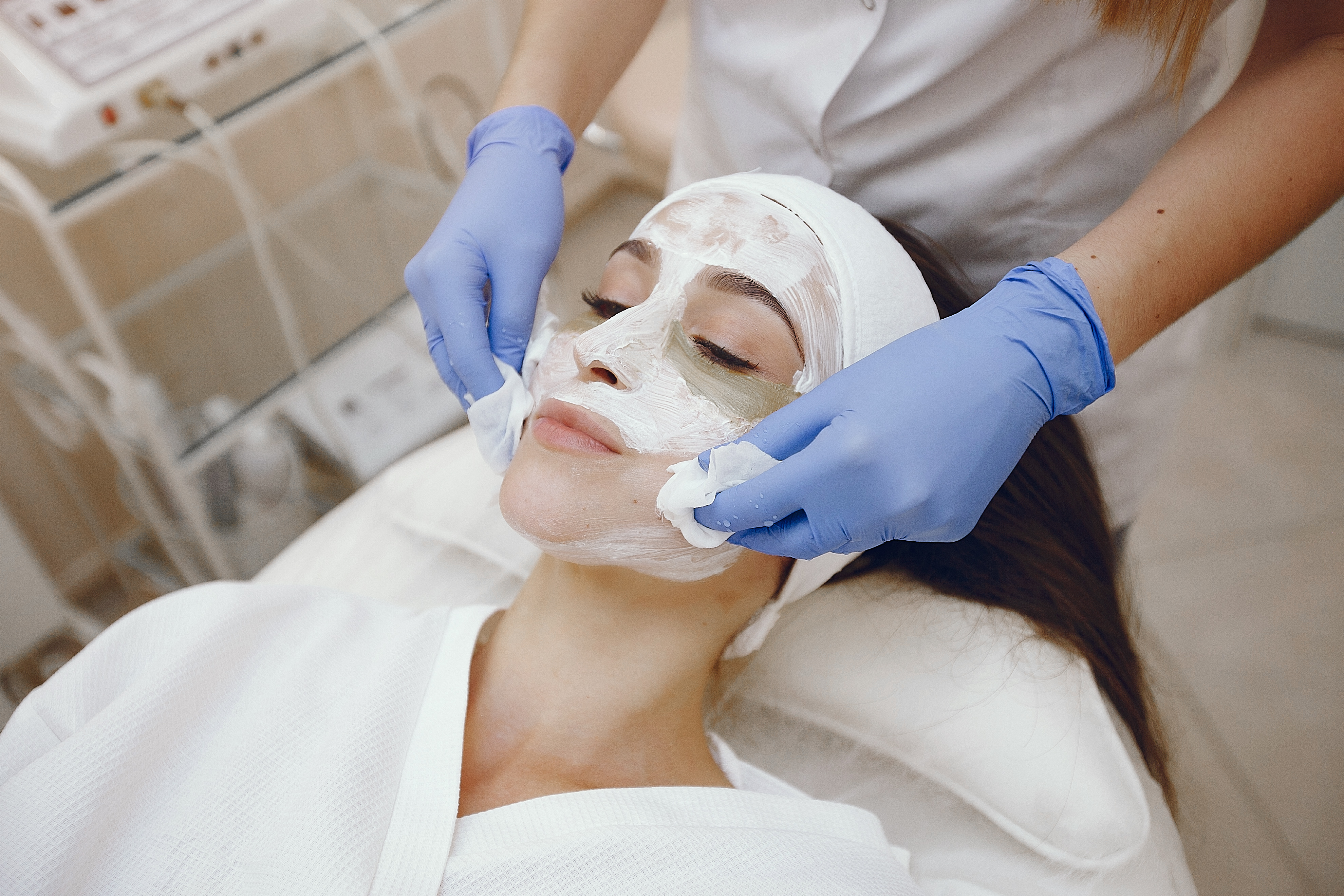 Cosmetologist treats client's skin. Woman with cosmetologist. having a chemical peep.Lady in a beauty studio.